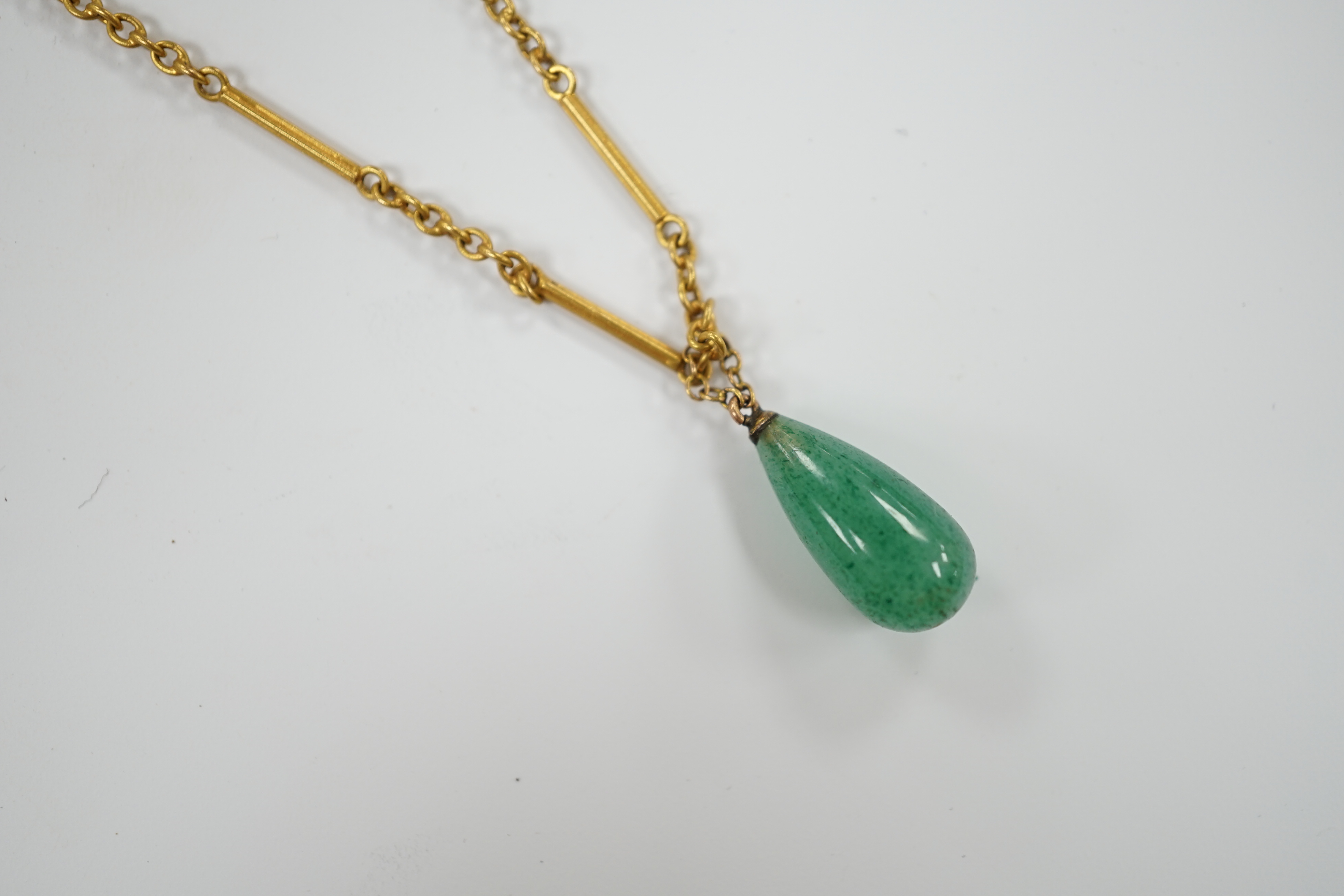 An early 20th century 15ct and single stone pear shaped simulated jade set pendant necklace, overall 46cm, gross weight 6 grams. Condition - good